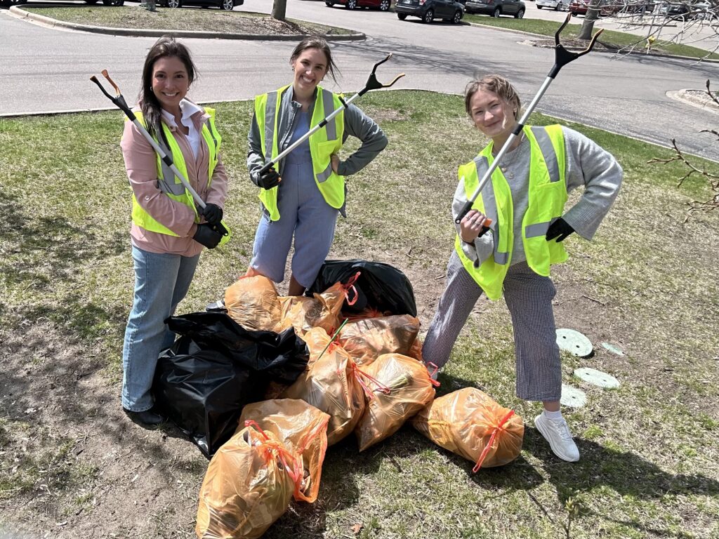 Employees helping clean up the neighborhood for Earth Day 2024
